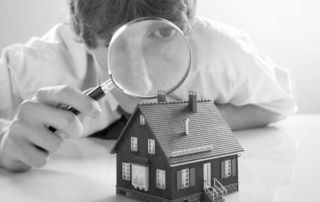 Estate agent with magnifying glass