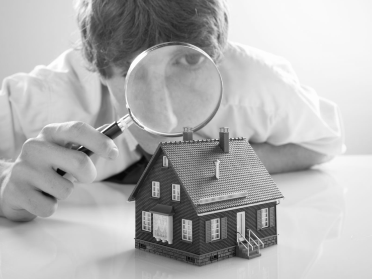 Estate agent with magnifying glass