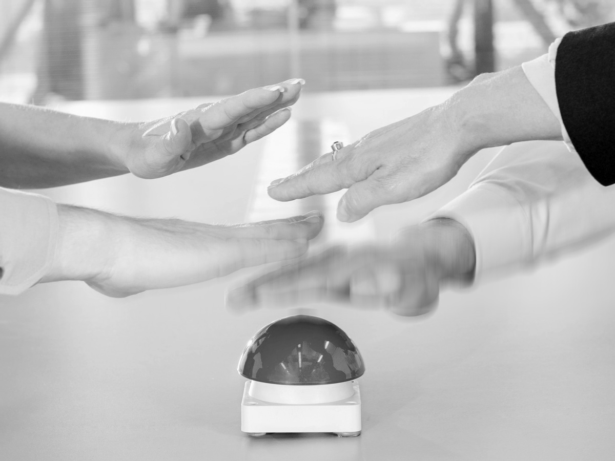 Buzzing in: hands competing to press a buzzer