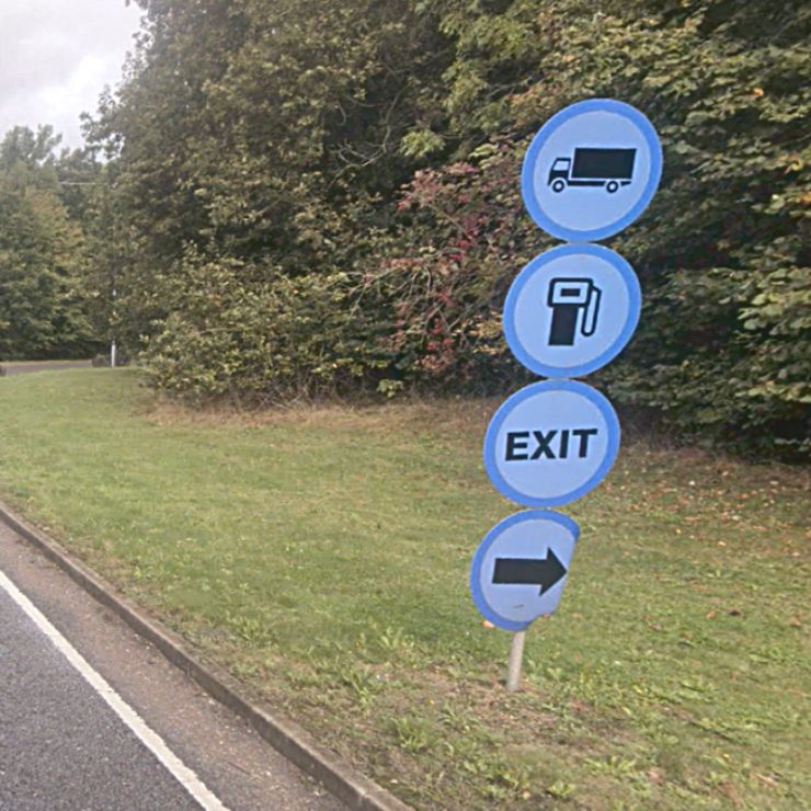 Confusing direction signage at a service station.