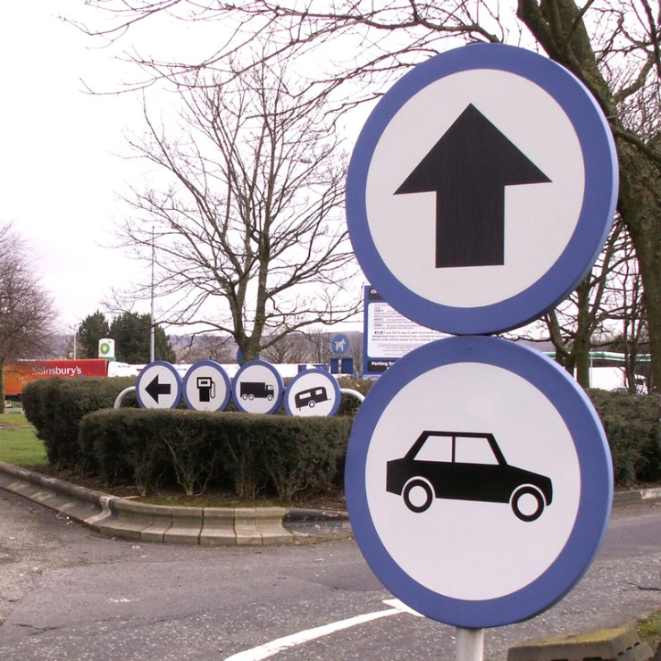 Confusing direction signage at a service station.