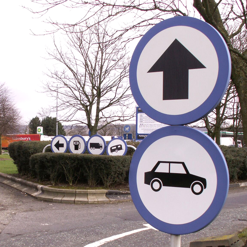Confusing direction signage at a service station.