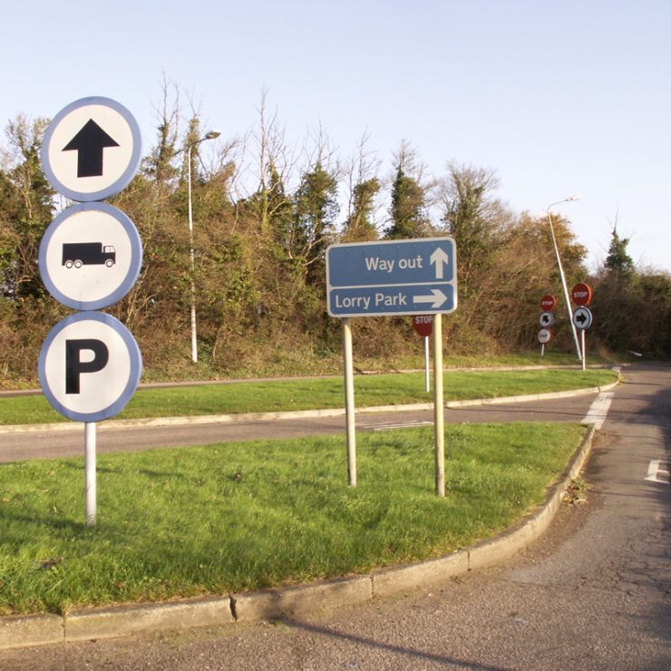 Confusing direction signage at a service station.