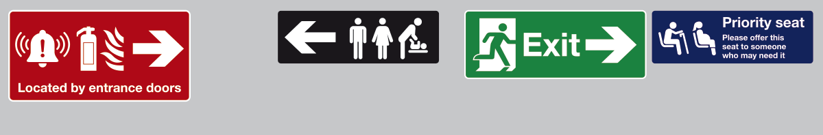 Four signs above the windows in a train carriage in a cluttered, hard to process arrangement.